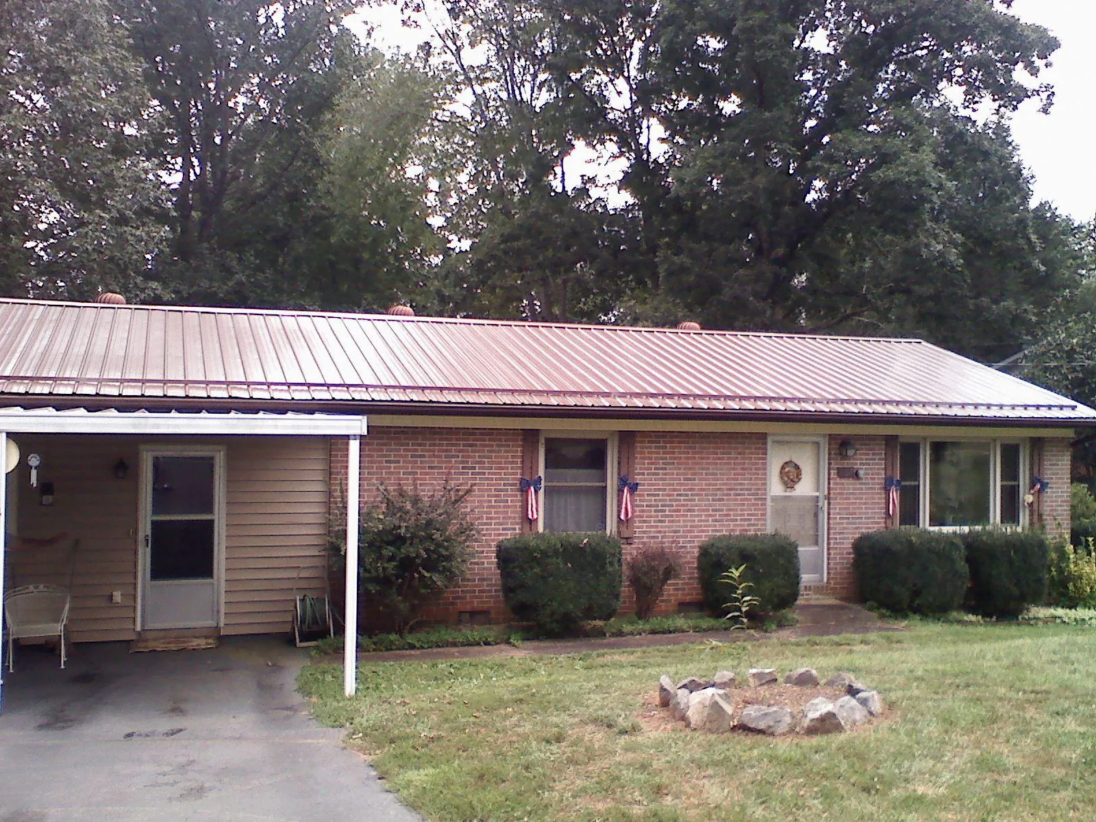 Bronze metal roof and carport on a brick ranch home — Roof Repair work by our crew in San Quentin